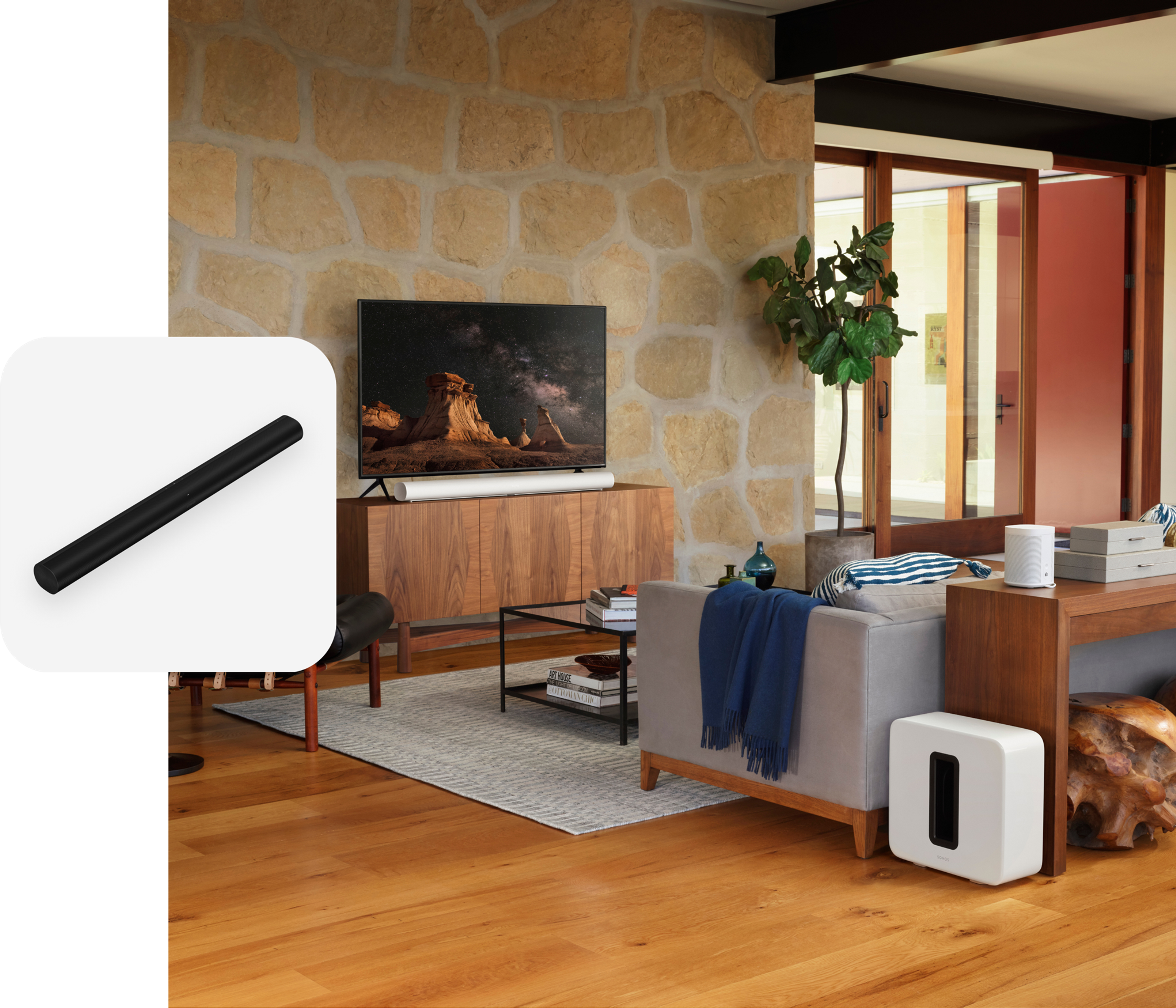 A home theatre setup in a living room featuring white Sonos Arc, Sub, and two Era 100 speakers