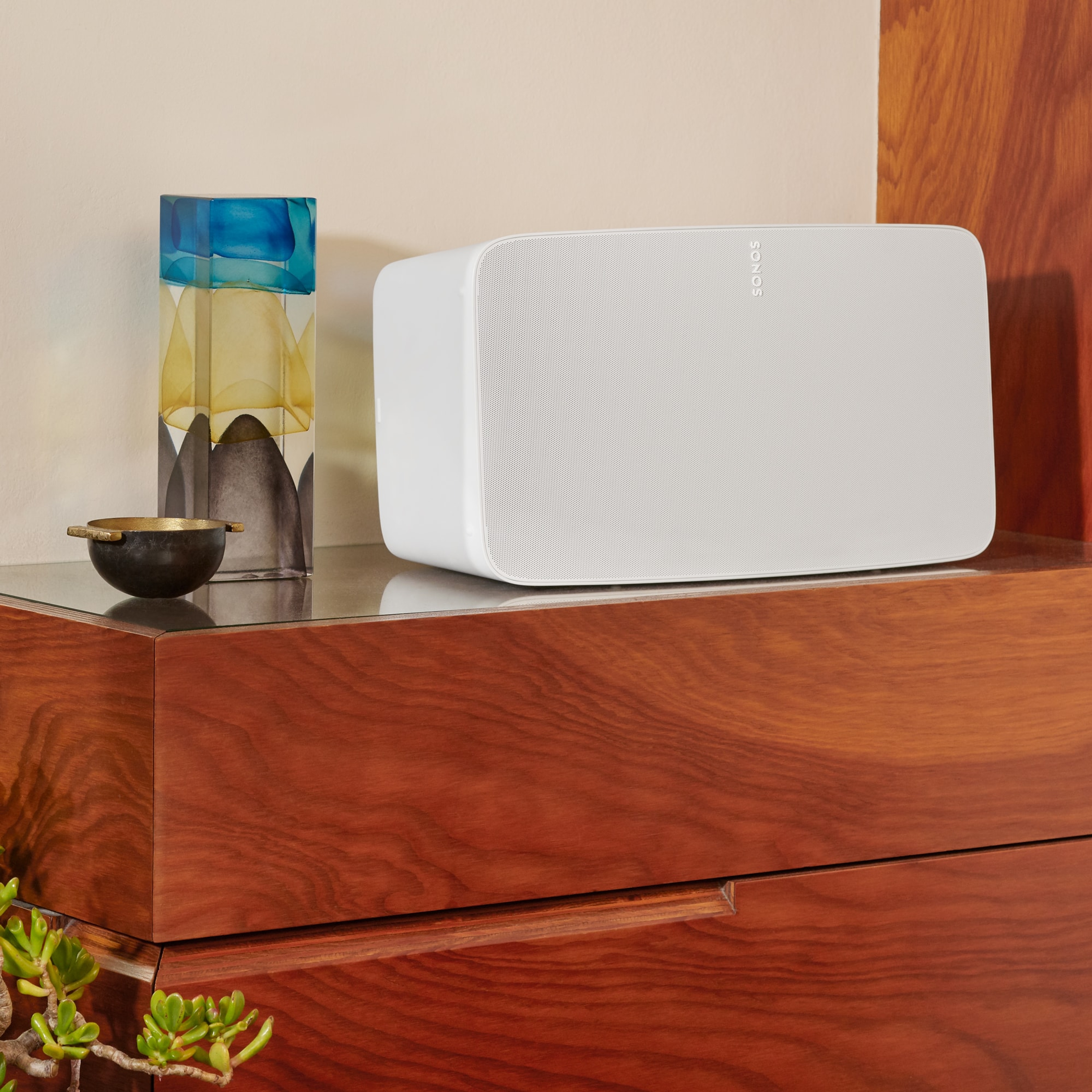 Ein auf einer Kommode platzierter Sonos Five in Weiß, der in einem Schlafzimmer für großartigen Sound sorgt