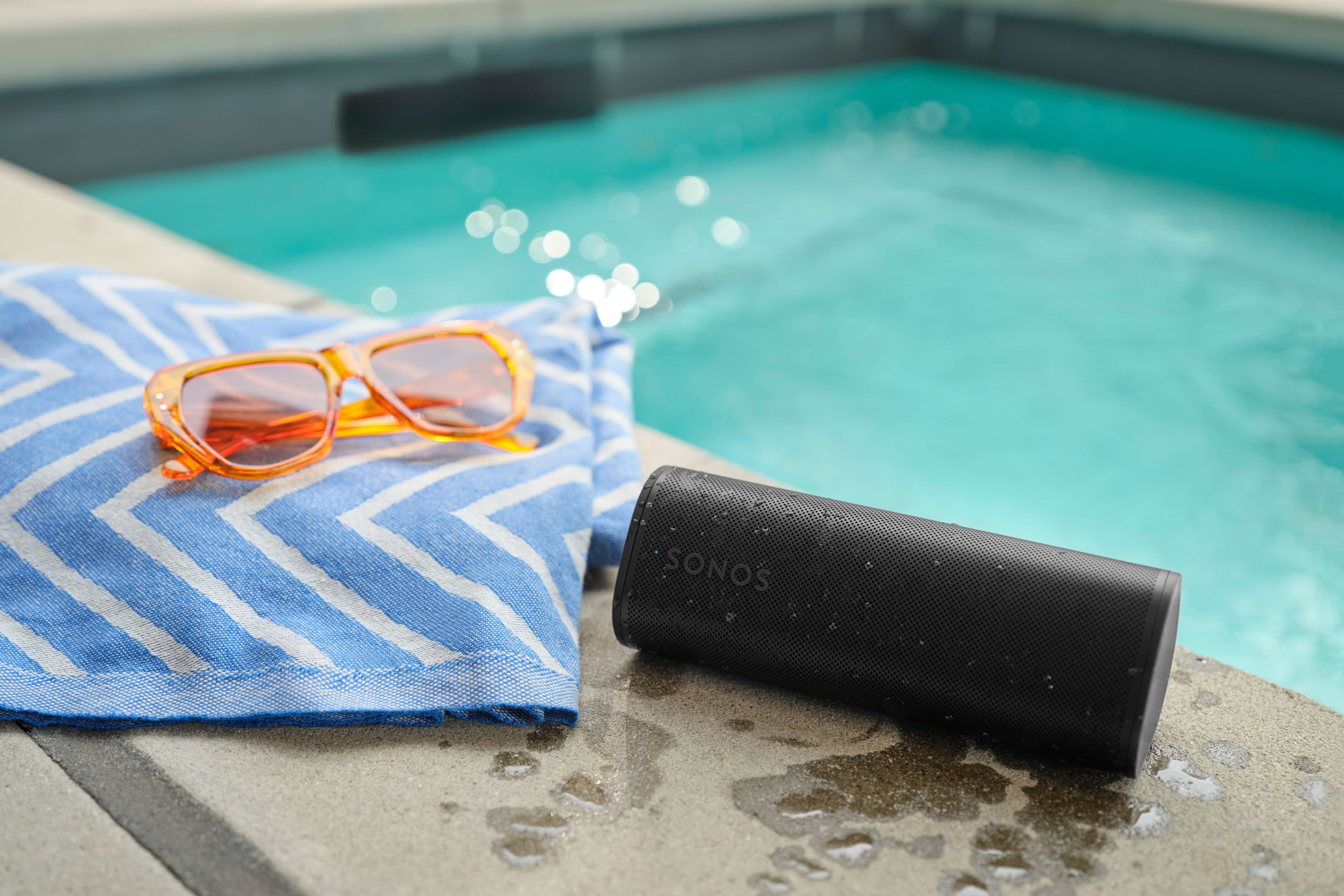 Black Roam 2 next to a pool and a towel
